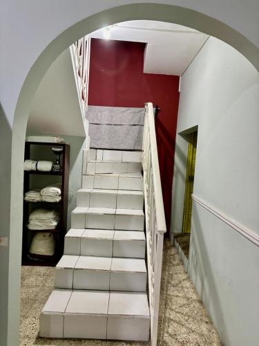 a staircase in a room with a red wall at Casa María Bonita in Boca del Río