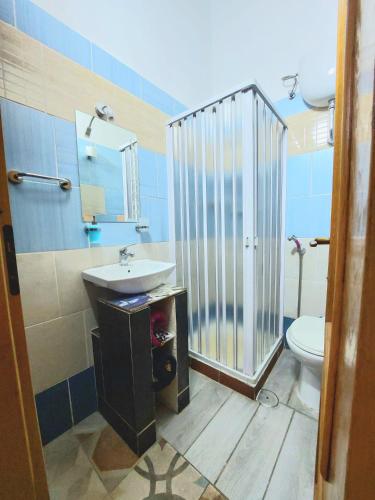 a bathroom with a sink and a shower and a toilet at B&B Cappotto civico 48 in Pompei