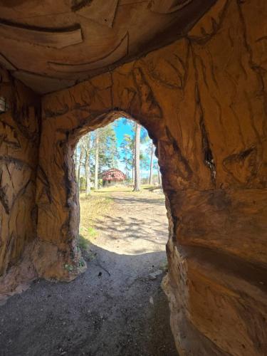 an archway in a stone building with trees in the background at Norrqvarn Hotel & Resort by Vänerport in Lyrestad