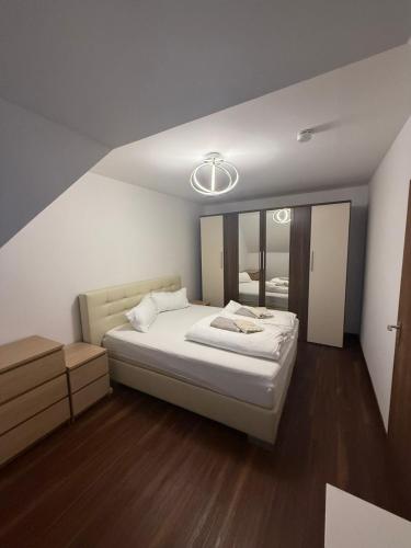 a bedroom with a large bed and a mirror at Old town comfort and cozy apartment 2 in Dachau