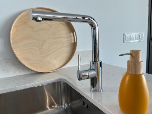 a kitchen sink with a wooden soap dispenser next to it at Casa Posterus, villa met prive zwembad in Dolores