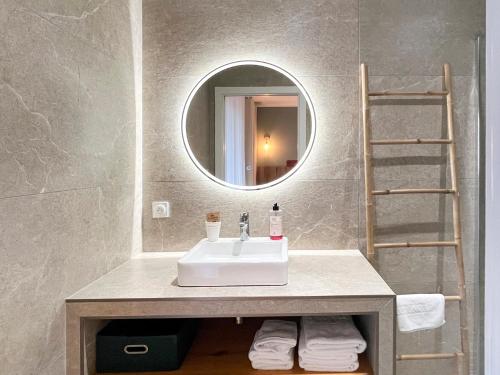 a bathroom with a sink and a mirror at Auberge les Oliviers in Lucciana