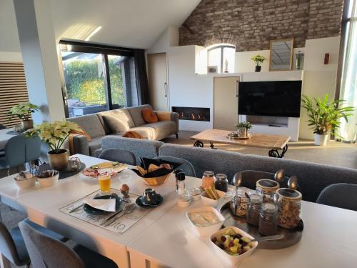 a living room with a table with food on it at Mariafarm in Zevenbergen