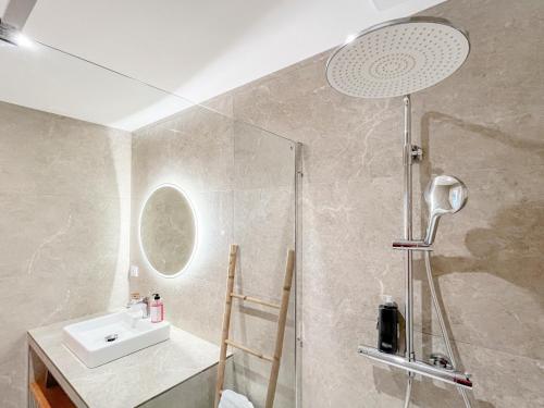 a bathroom with a shower and a sink at Auberge les Oliviers in Lucciana