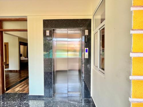 a hallway of a house with a glass elevator at Lykke Suites- 2-min Drive to Colva Beach-By Goan Felicidade Hospitality PVT LTD in Colva