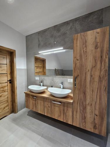 a bathroom with two sinks and a large mirror at Malowany Las in Międzybrodzie Bialskie