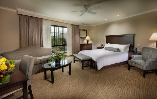 a large hotel room with a bed and a couch at Coast Anabelle Hotel in Burbank