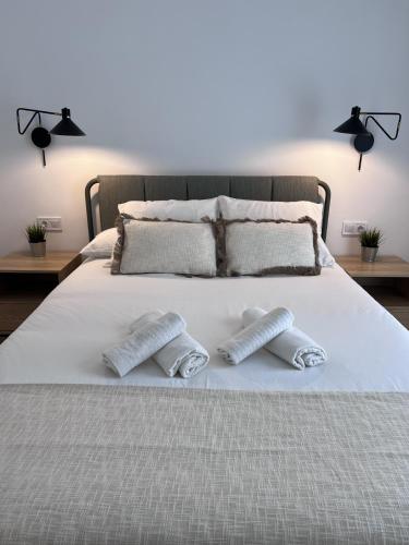 a white bed with two pillows on top of it at Villa de Béjar 2 in Béjar