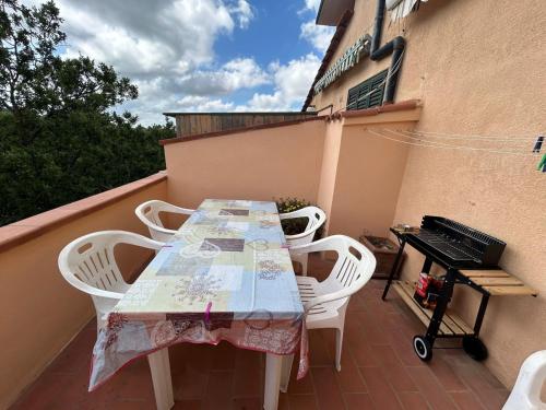 a table and chairs on a balcony with a keyboard at house solemonte in Montescudaio