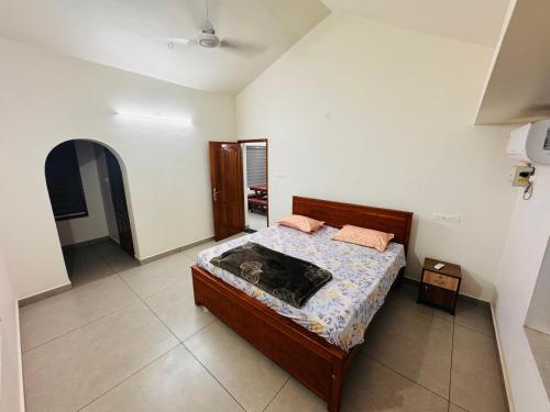 a bedroom with a bed in a room at BougainVilla in Trivandrum