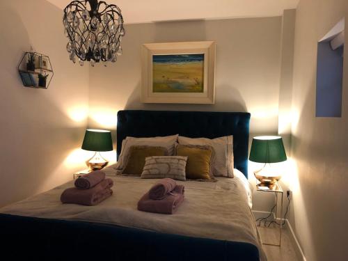 a bedroom with a bed with two towels on it at Beautiful renovated stone house for Dog friendly, Quayside location in Newport