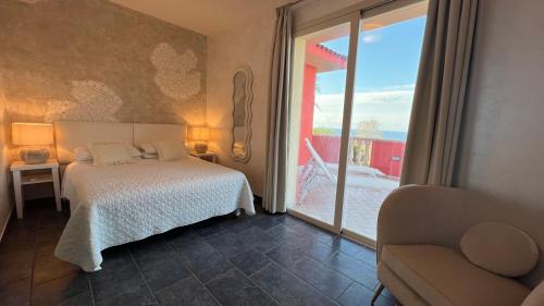 a bedroom with a bed and a large window at Borgo di Santa Barbara in Santa Domenica