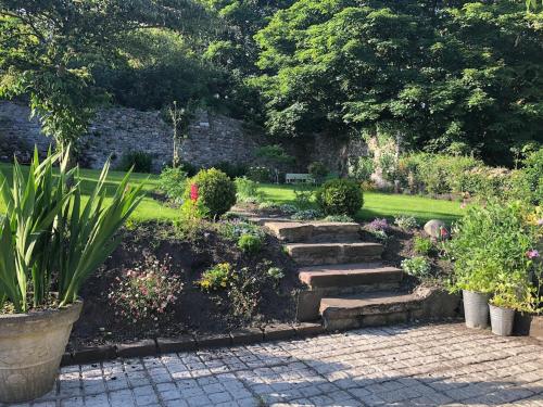 a garden with a stone path and some plants at Beautiful renovated stone house for Dog friendly, Quayside location in Newport