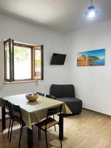 a living room with a table and a couch at La Chianconata in Vieste