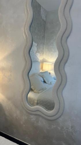 a reflection of a bed in a mirror at Borgo di Santa Barbara in Santa Domenica