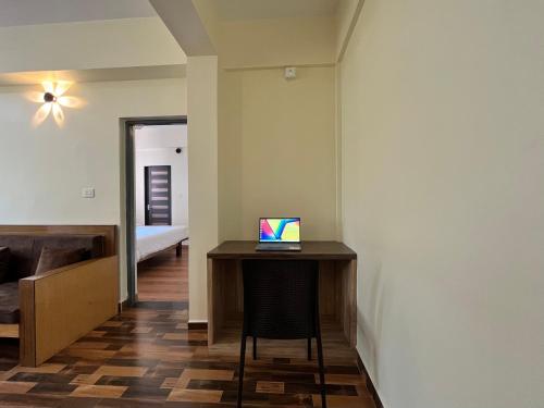 a room with a desk with a laptop on it at Lykke Suites- 2-min Drive to Colva Beach-By Goan Felicidade Hospitality PVT LTD in Colva