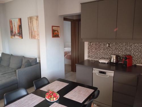 a kitchen and living room with a table and a couch at Zoe's Apartment in Pídima Kyrás