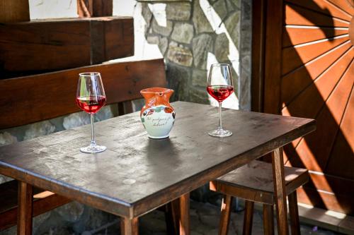 three glasses of red wine sitting on a table at Countryside house in Male Brusnice