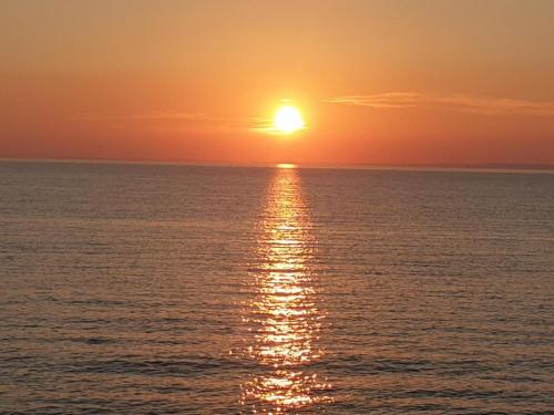 a sunset over the ocean with the sun setting at Apartment Salvia - Stivan, Cres - 900 m to Merascica beach in Štivan