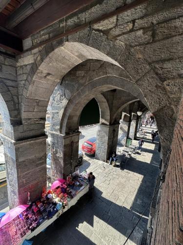 a stone archway with a market underneath a bridge at Suite degli Archi - Genova Fronte Acquario in Genova