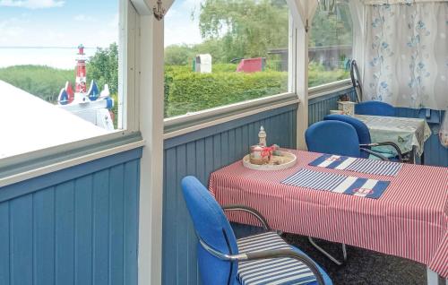 a porch with a table and chairs and a lighthouse at Ferienhaus Kummerow in Kummerow