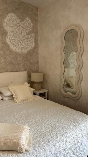 a bedroom with a bed and a large mirror at Borgo di Santa Barbara in Santa Domenica