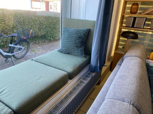 a couch sitting in a room with a window at Apartment Seehund in Kiel