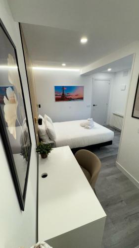 a small room with a bed and a table at JACUZZI ROOMS Atocha in Madrid