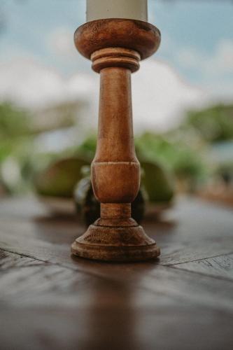 a small wooden candle stick sitting on a table at Villa Manika vue mer in Le Moule