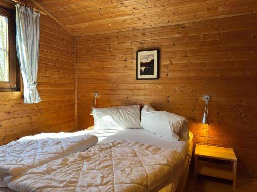 a bedroom with a bed in a log cabin at Ferienhaus in Hechthausen in Hechthausen
