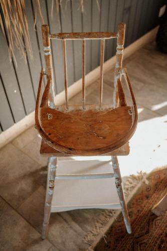 a wooden chair sitting in a room at Villa Manika vue mer in Le Moule