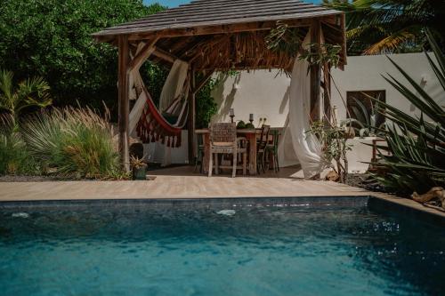 a backyard with a gazebo and a swimming pool at Villa Manika vue mer in Le Moule