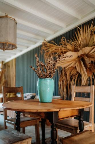 a blue vase sitting on a wooden table at Villa Manika vue mer in Le Moule