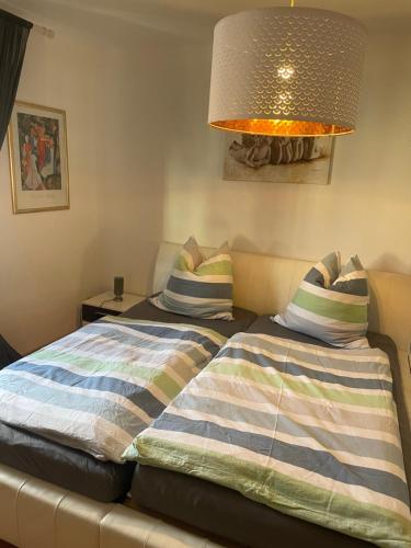 a bedroom with two beds and a lamp at Silberwurz in Bad Reichenhall