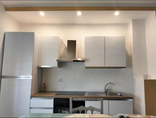 a kitchen with white cabinets and a sink at B&B La Villetta Salerno Airport in Montecorvino Pugliano