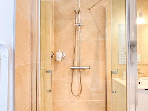 a bathroom with a shower with a glass door at L'Étoilé - Parking Gratuit, Confort & Design Chic in Saint-Brieuc