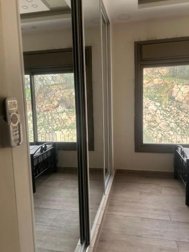 a room with two mirrors in a room with a window at The Pearl of Jerash in Jerash