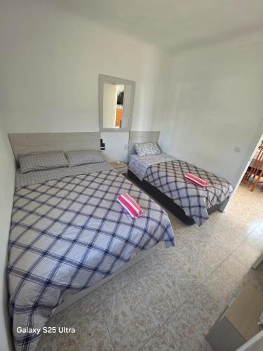 two twin beds in a room with a mirror at Casa Rural Natur Libre in Alicante