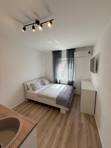 a small bedroom with a bed and a window at Michael's in Zadar