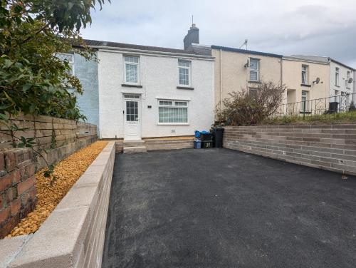 an empty parking lot in front of a house at Ty Collective - Near Town Centre in Dowlais