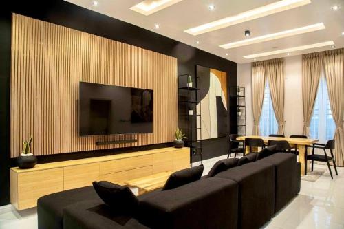 a living room with a large couch and a television at Modern 3BR Apartment with Game Room in Lekki in Ibeju