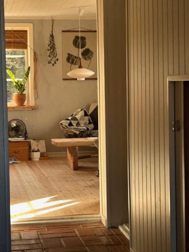 a living room with a couch and a mirror at Hus i Heda in Ödeshög