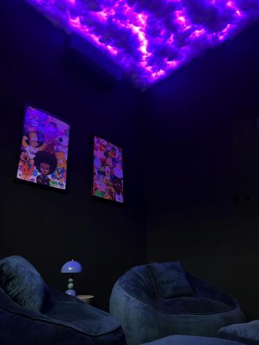 a living room with purple lights on the ceiling at Modern 3BR Apartment with Game Room in Lekki in Ibeju