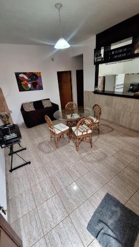 a living room with a table and chairs and a couch at Apartamentos Marconi in Resistencia