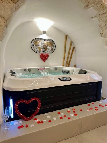 a jacuzzi tub with a heart on it at Ostuni Luxury Room in Ostuni