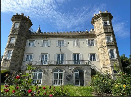 an old stone building with a clock tower on it at Château Philip in Saint-Genest-Lerpt