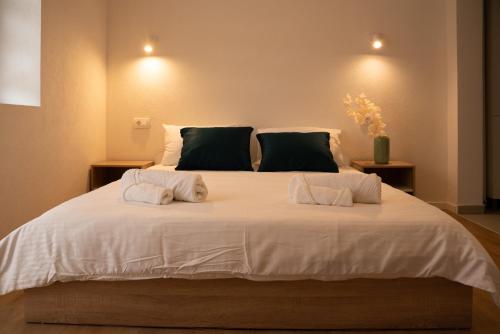 a bedroom with a large white bed with two pillows at Iris Apartments in Ohrid
