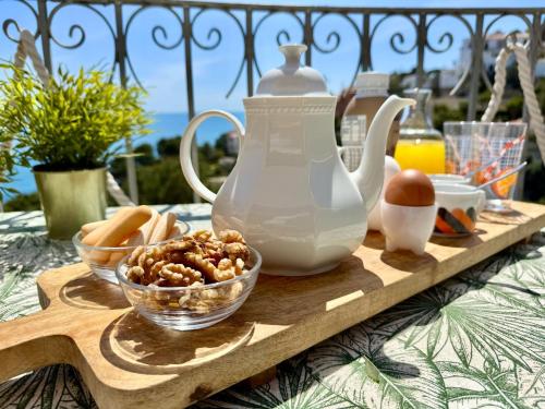 a table with a tea pot and a bowl of nuts at Casa Halcón in Jávea