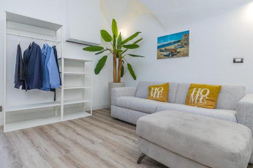 a living room with a couch and a chair at The Beach One in Varigotti