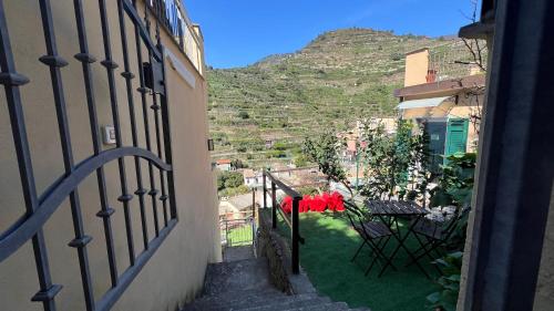 a view from an apartment balcony with a table and chairs at Orizzonti Apartments in Manarola